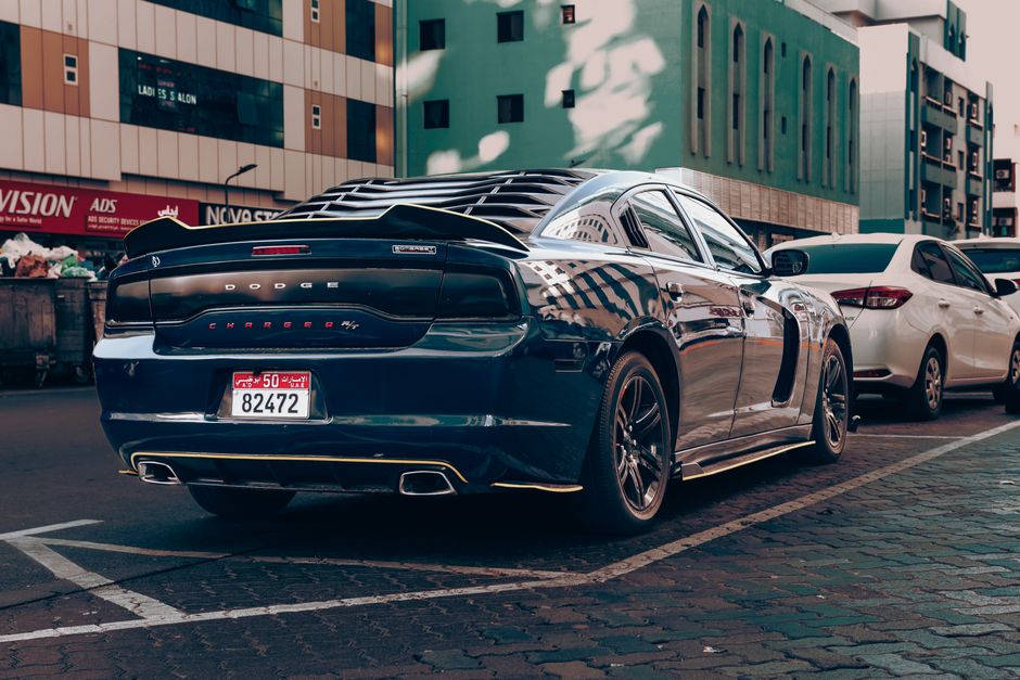 Luxury Dodge Charger parked in an urban Abu Dhabi setting, showcasing wealth and style